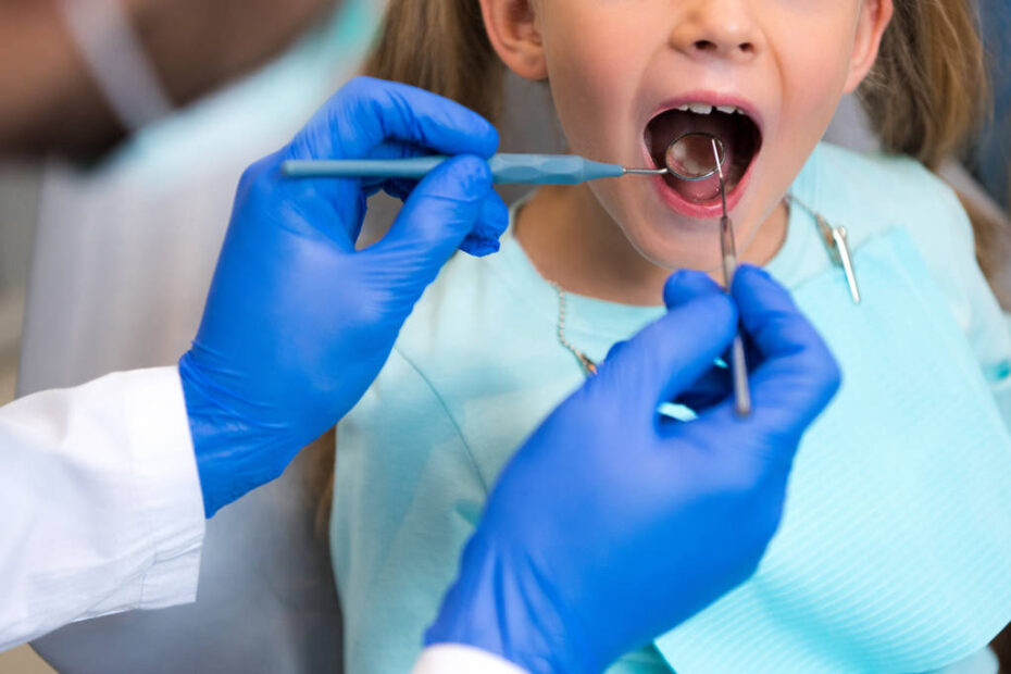 dentist examining teeth of little child